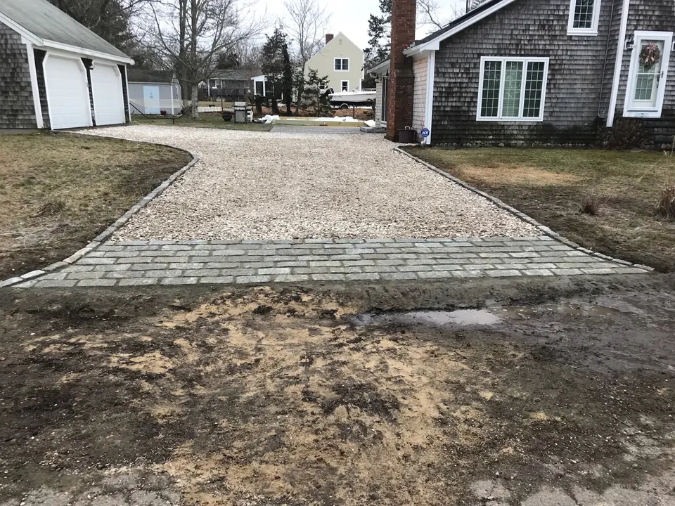 Cobblestone apron set at the end of a crushed stone drive