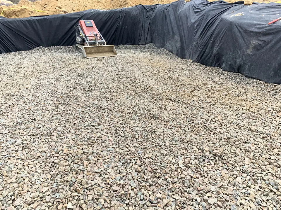 Fabric-lined excavation with a crushed stone bed