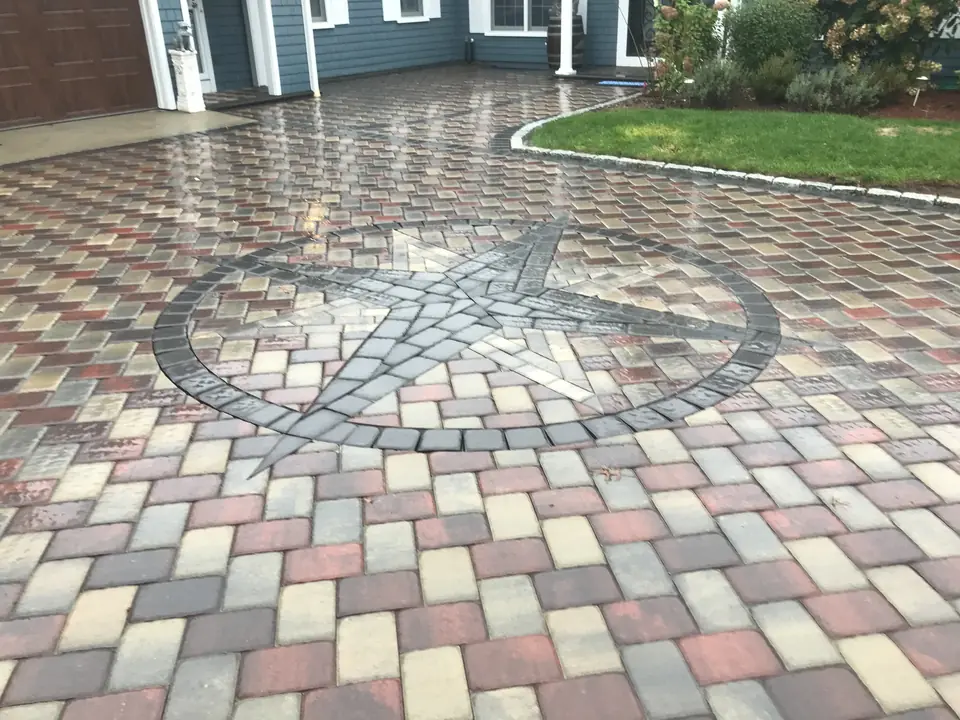 Compass rose inlaid in a paver driveway