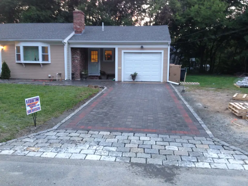 Paver driveway with a border course and a cobblestone apron