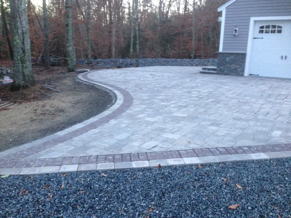 Curved paver driveway with a border course