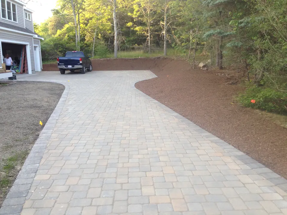 Long paver driveway with a border course