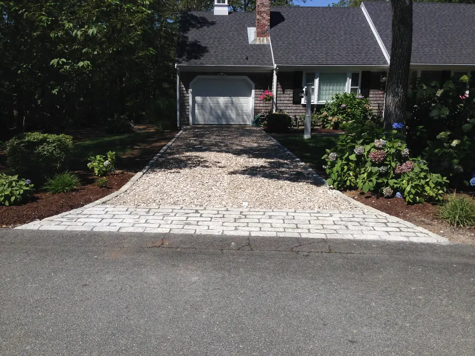 Crushed stone driveway with a cobblestone apron