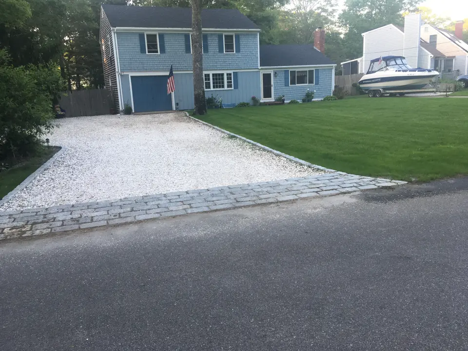 Crushed stone driveway with a cobblestone apron