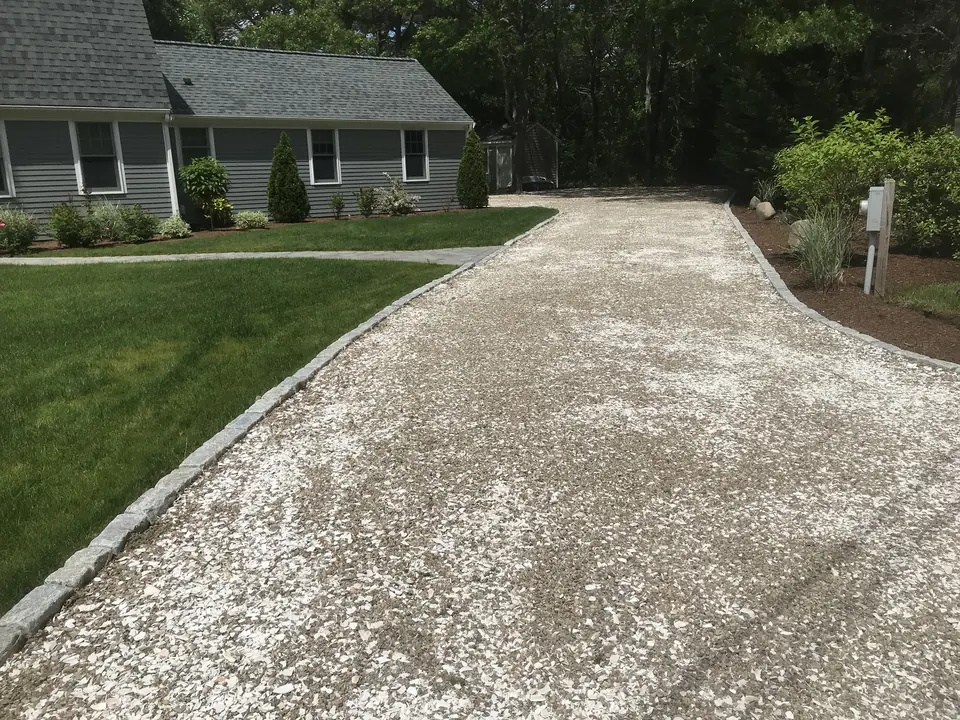 Crushed stone driveway to a Cape