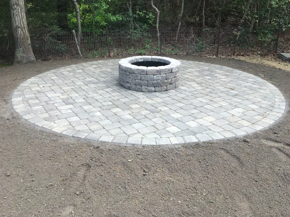 Circular paver pad with a stone fire ring