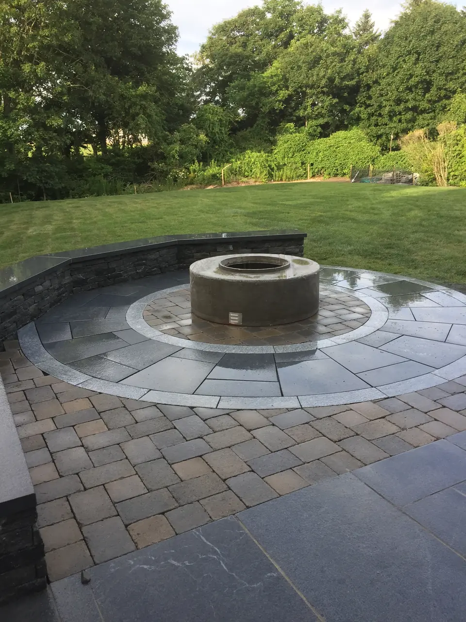Fire pit inside a circle of pavers with a bluestone ring