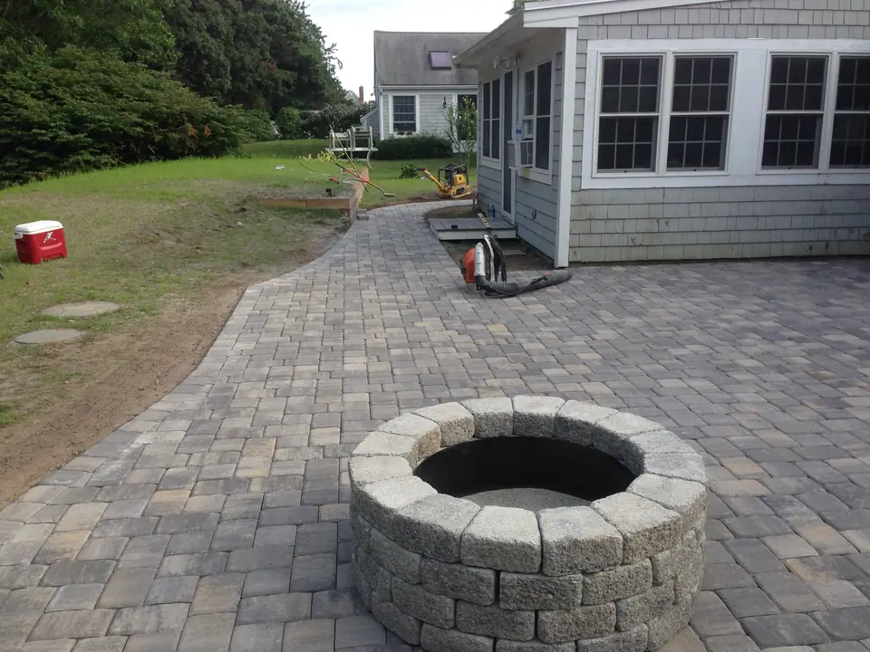 Paver patio and fire pit along the side of the house