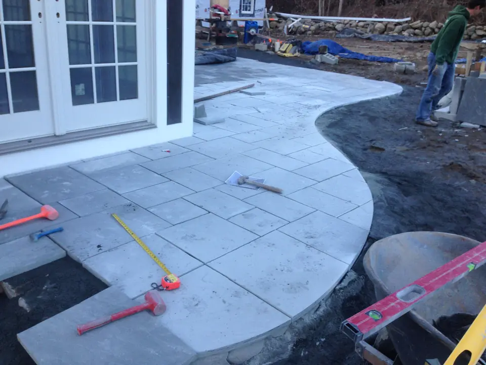 A curved bluestone patio being cut and laid