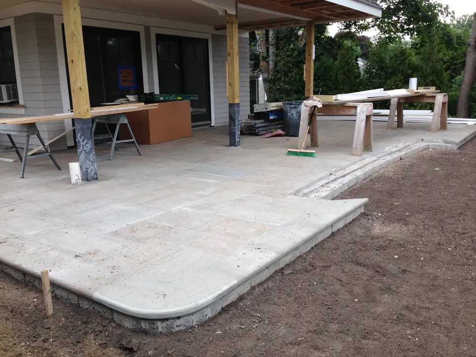 Stone patio with a rounded corner, before the cleanup