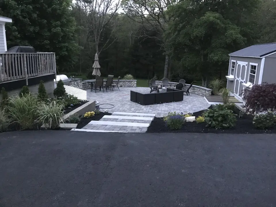 Patio, steps and plantings beside a new driveway