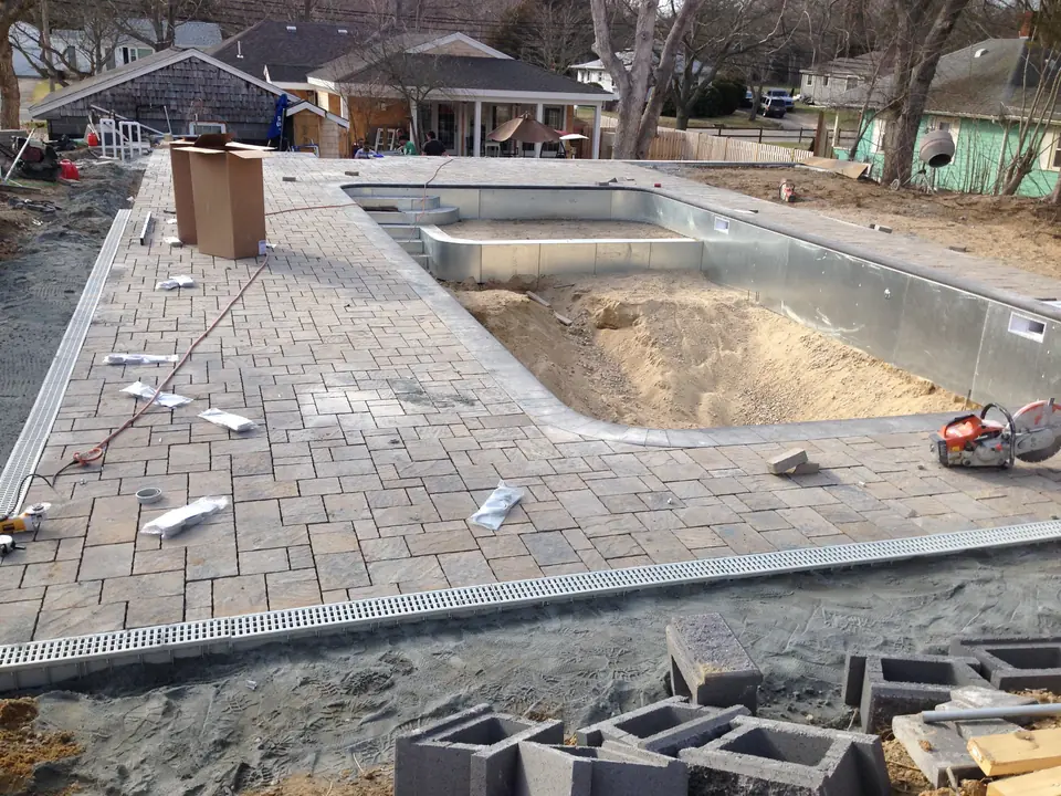 Paver pool deck going in around a new pool