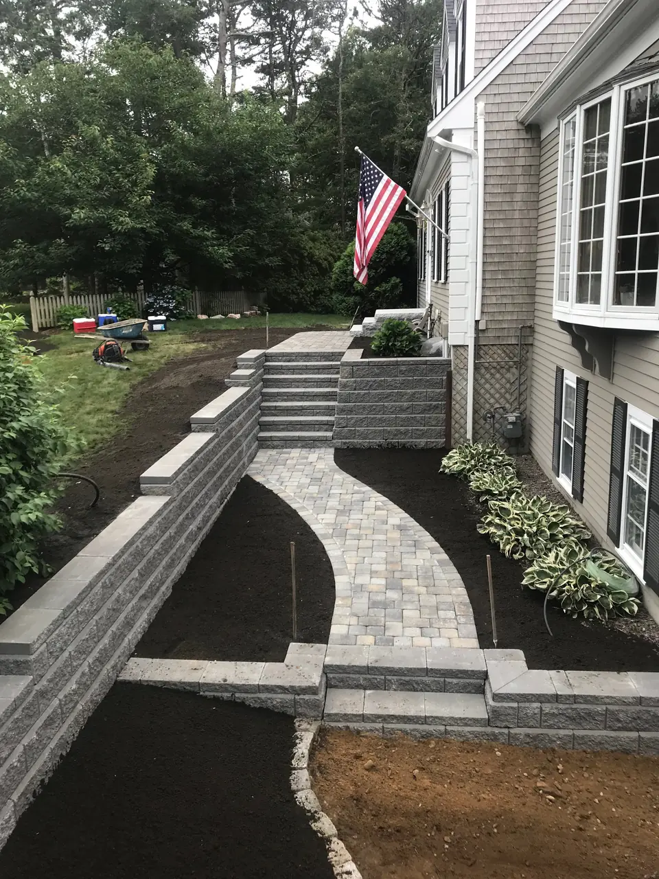 Paver walk, block walls and steps along the house