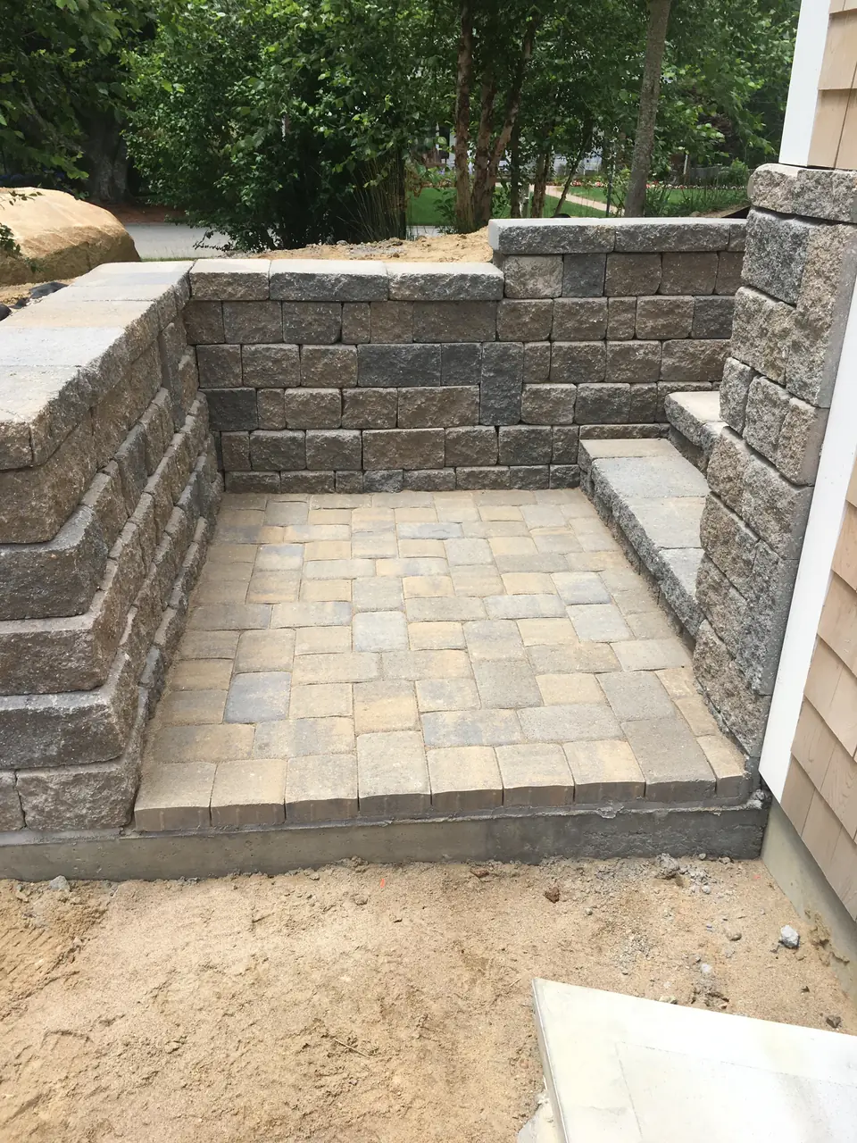 Block retaining walls around a paver landing