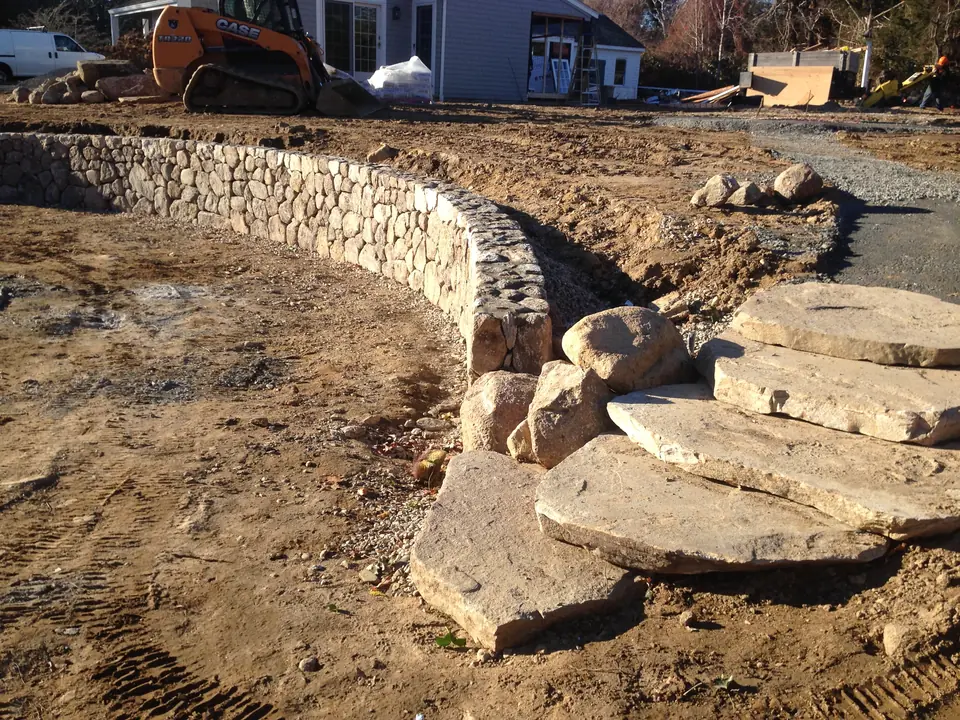 Curved fieldstone wall with stone slab steps